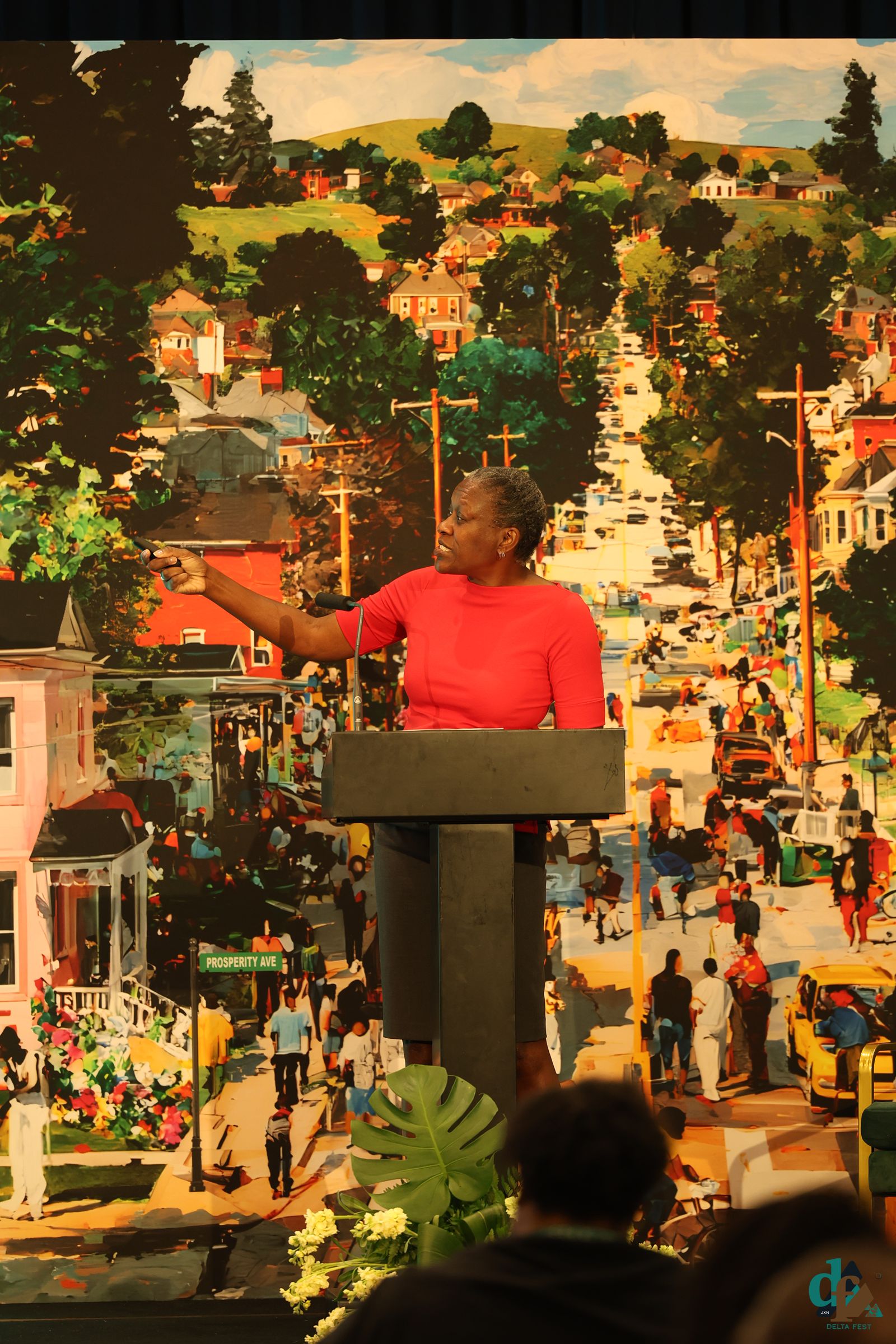 Speaker at the podium in front of DELTA FEST artwork