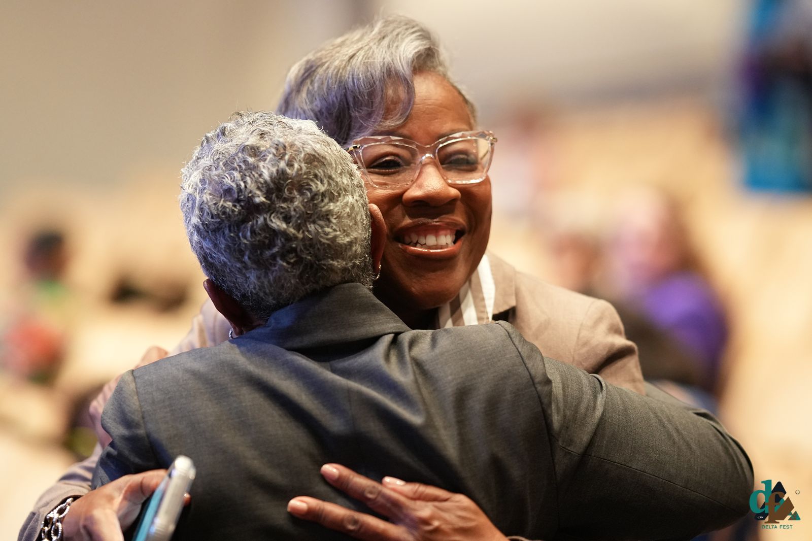 Attendees share a warm hug at DELTA FEST 2026